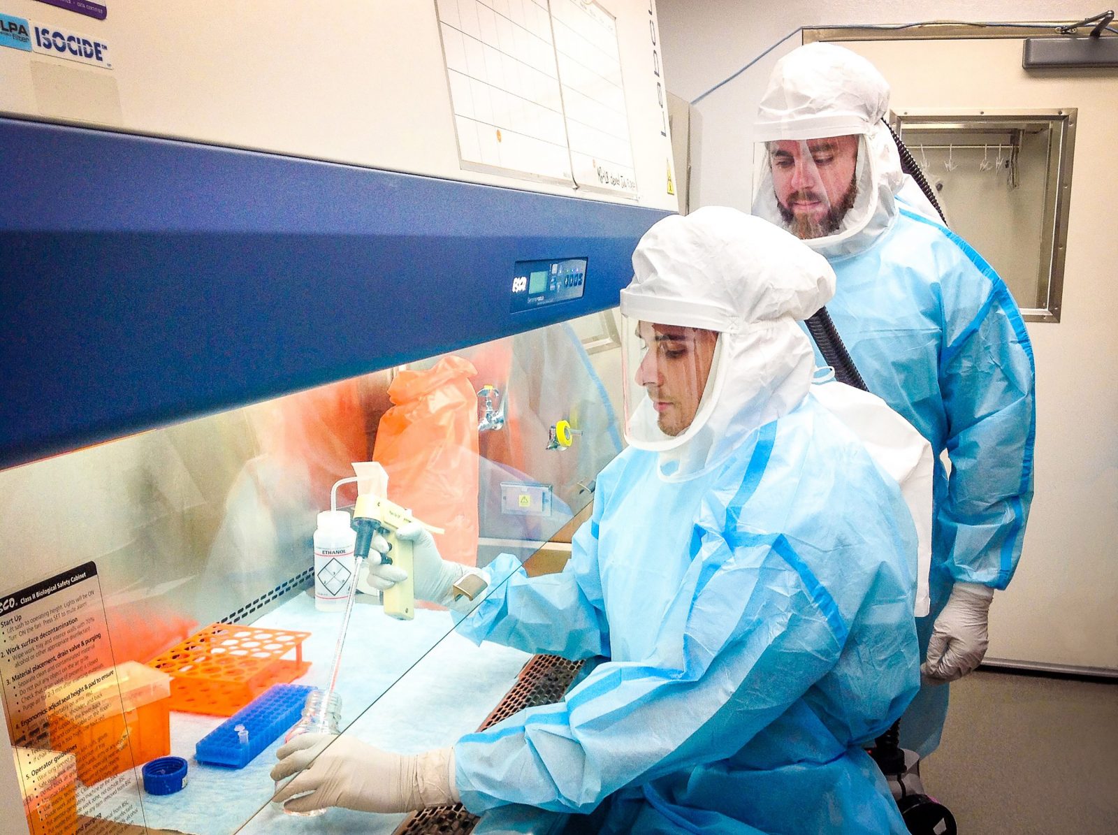 Brock University PhD student Jeremia Coish, left, and Associate Professor of Health Sciences Adam MacNeil work in BrockUniversity’s Level 3 containment laboratory. Photo by Mariana Garrido de Castro.