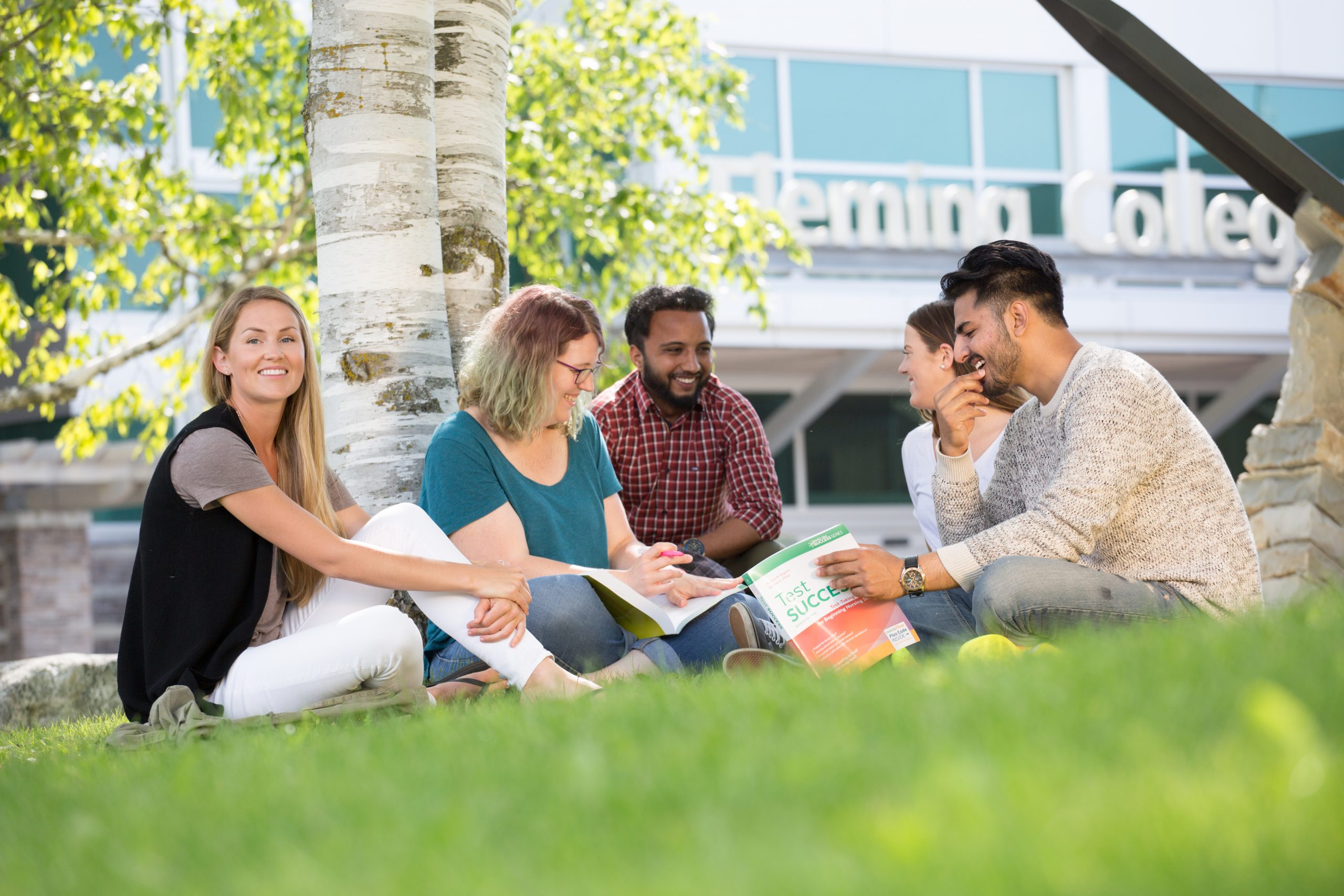 An image showing students at Sutherland Campus sitting out in front lawns