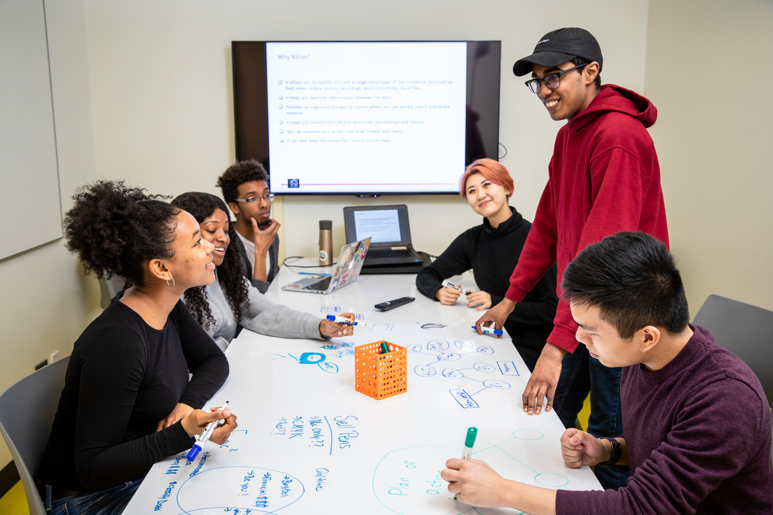 Students collaborating and studying in the TMU library's study spaces.