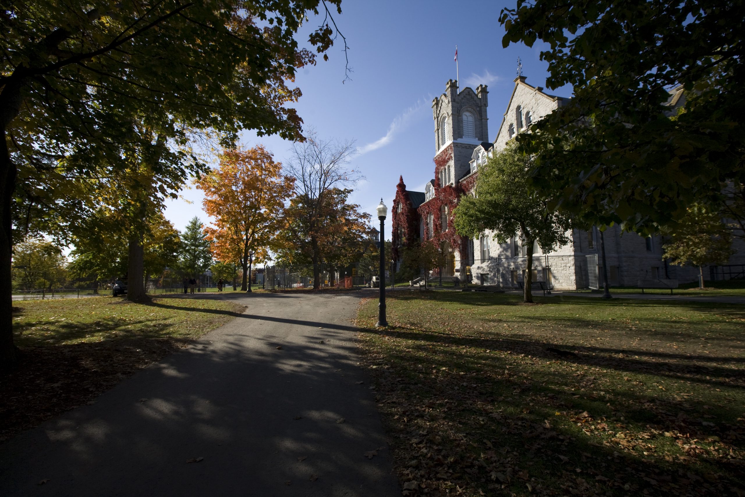 Drone photo of Queen's campus with Tindell field in the foreground and Lake Ontario in the background.