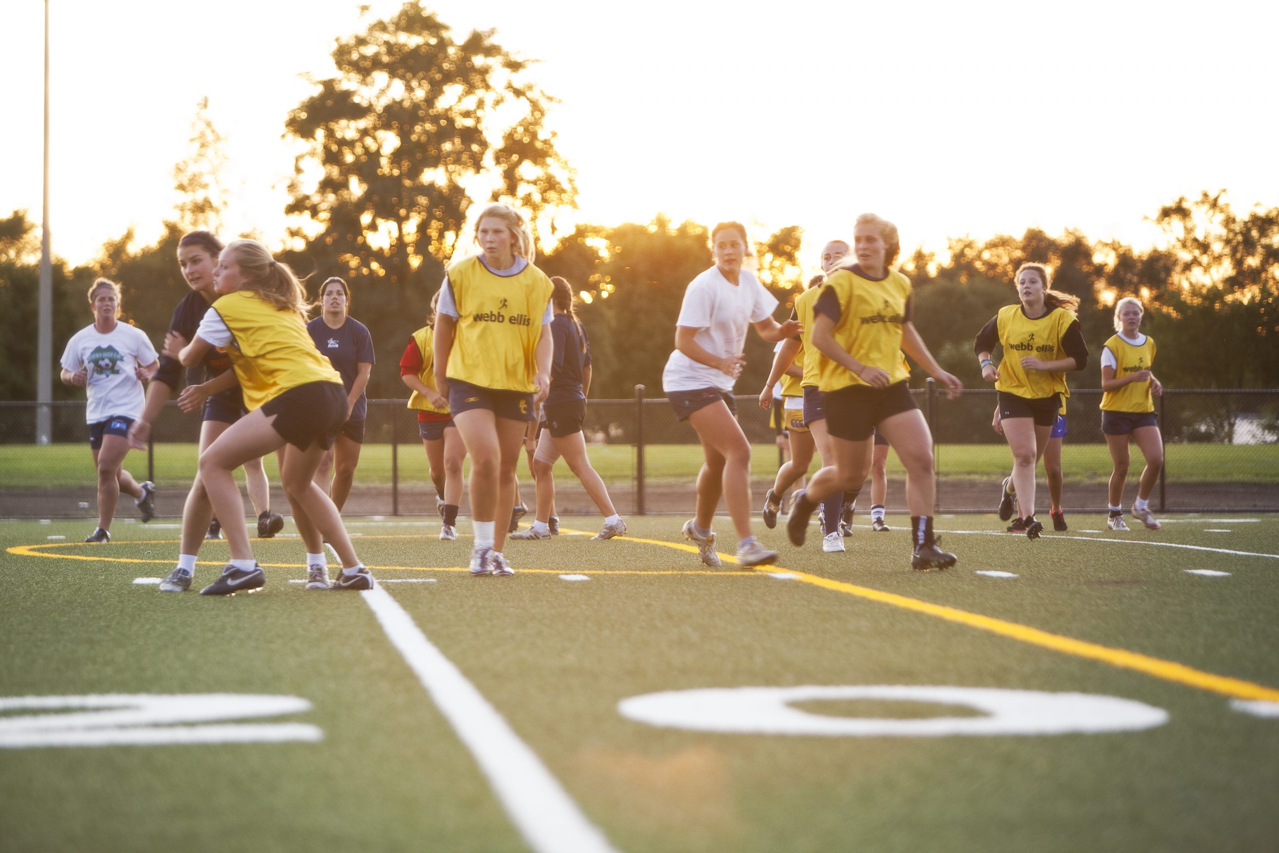 Photo of women’s rugby team at practice.