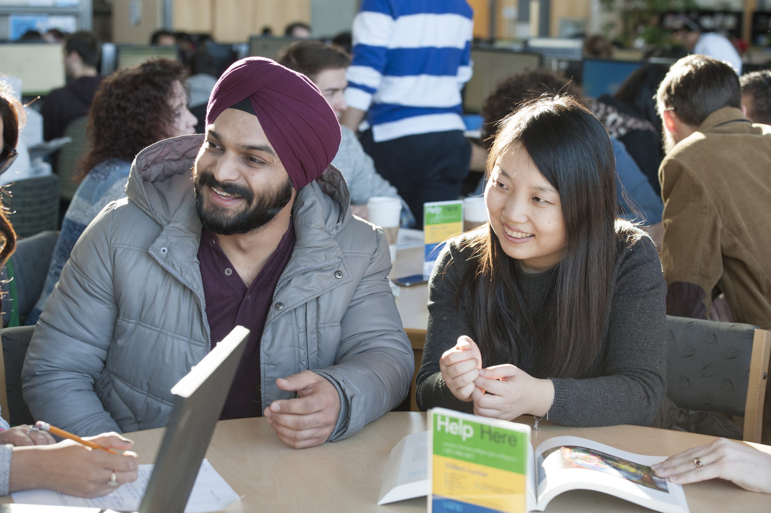 Students, smiling in the library