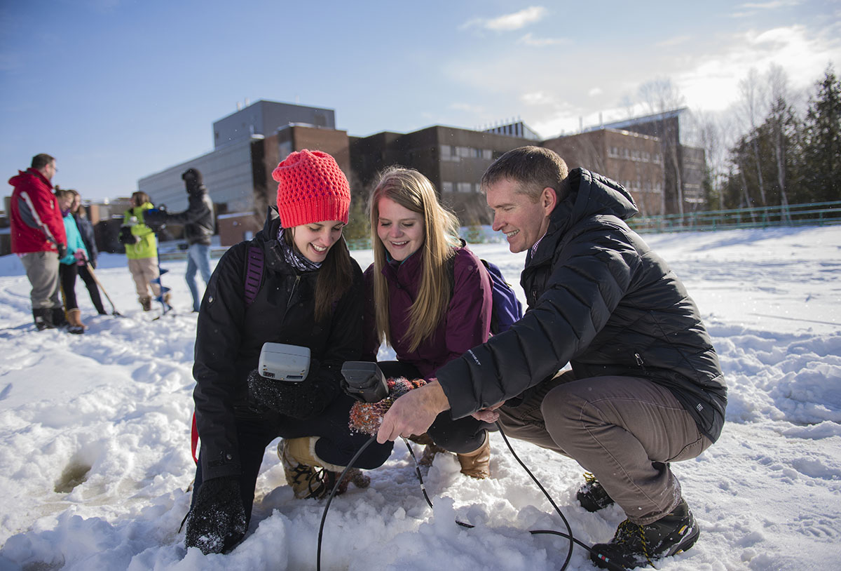Students learning outdoors behind campus