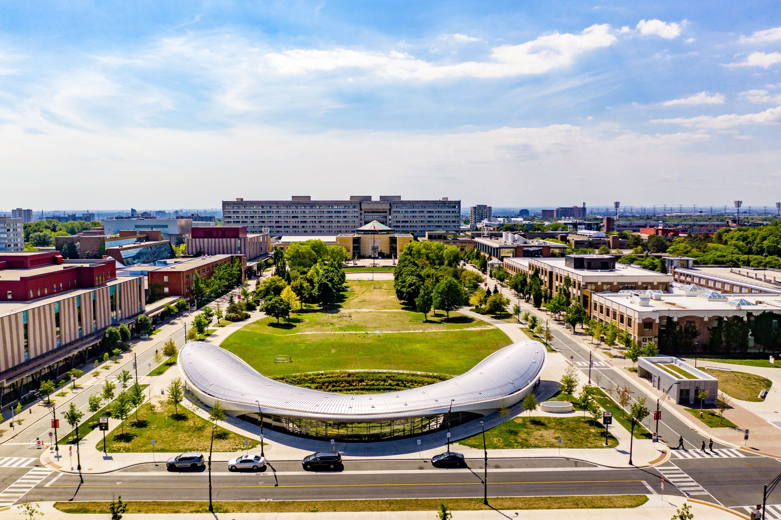 Aerial view of York University Keele campus subway station, grassy commons, trees and Vari Hall